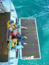 Boys fishing off the yacht