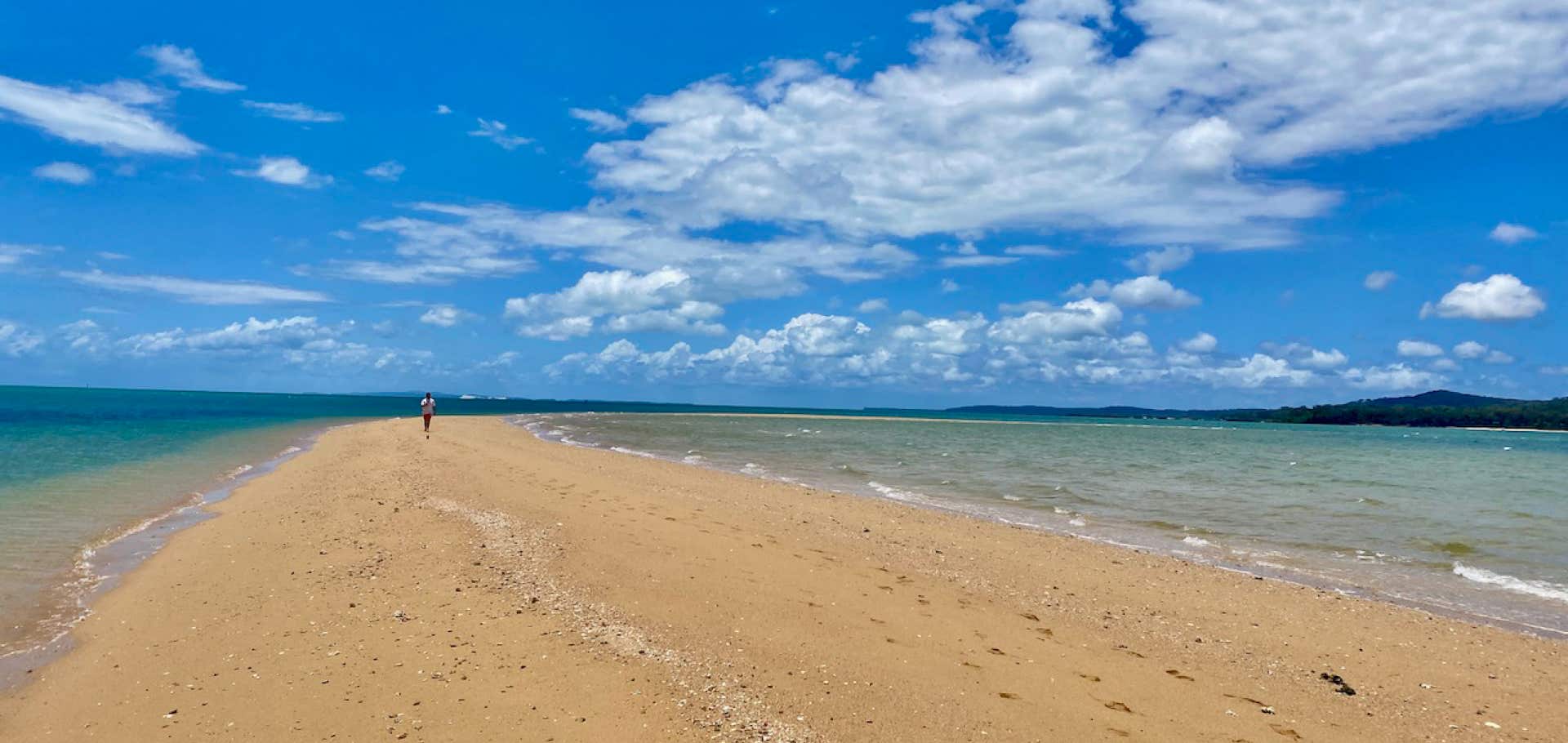 Guests strolling along the Bird Islet Sandbar on sailing yacht Curlew Escape on a private yacht charter at Moreton Bay, Brisbane.