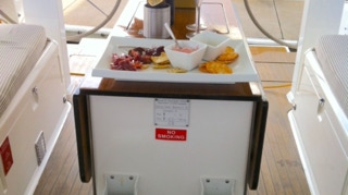 Snacks and wine on the cockpit table  on  Sailing Yacht Curlew Escape, available for private yacht charters on Moreton Bay, Brisbane.